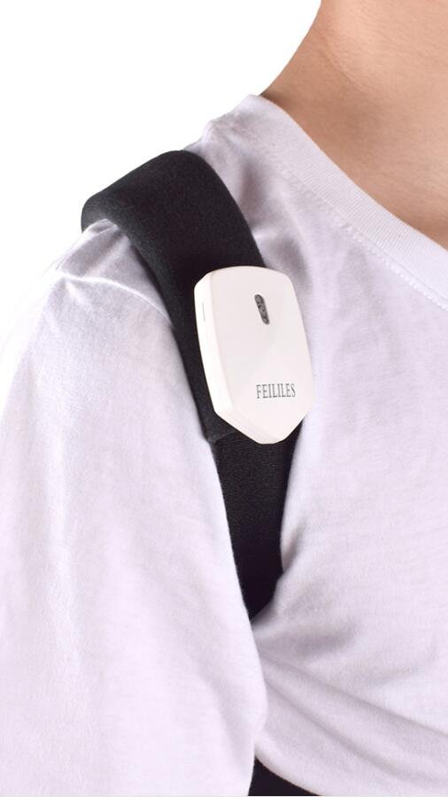 Close-up of electronic posture corrector on back