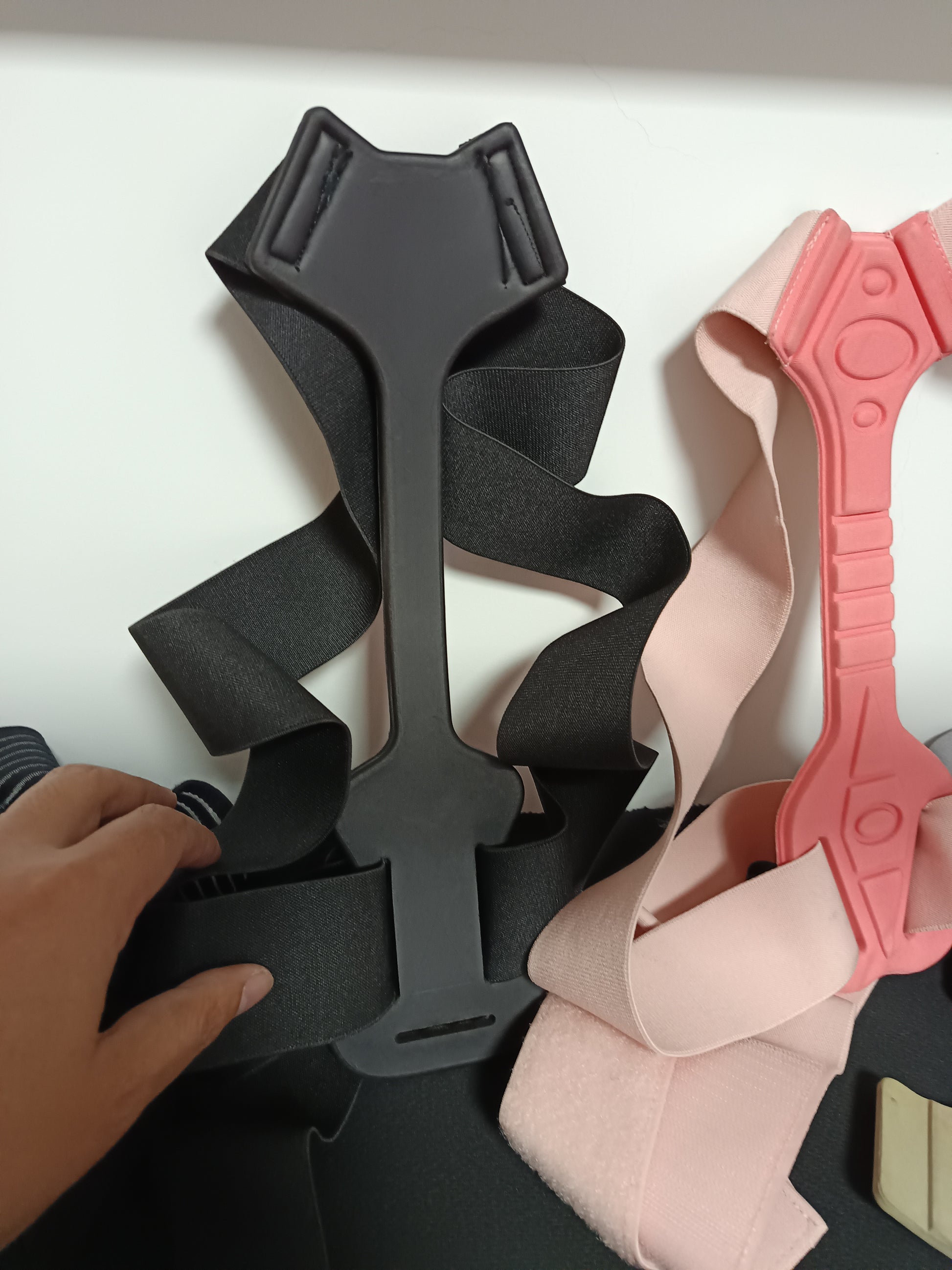 Using the posture corrector while working at a desk to prevent slouching